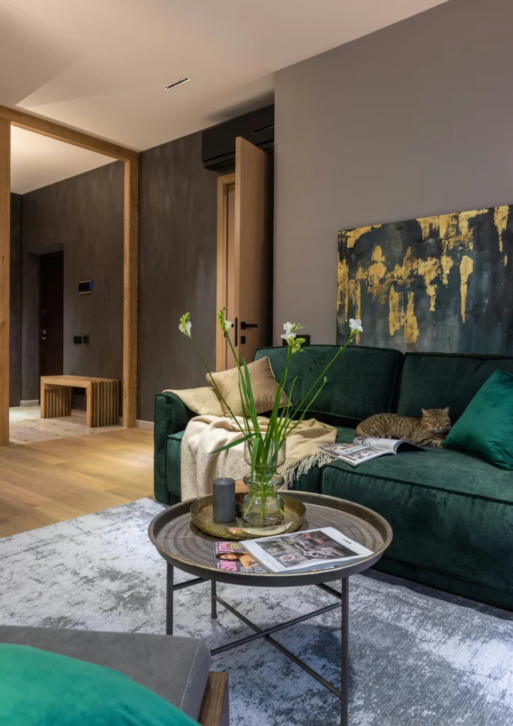 Emerald green sofa with abstract art and gold accents