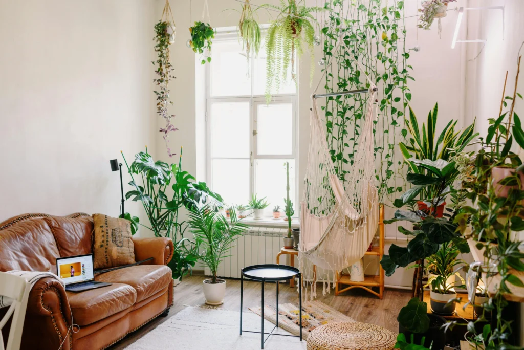 Living room filled with plants and hammock chair