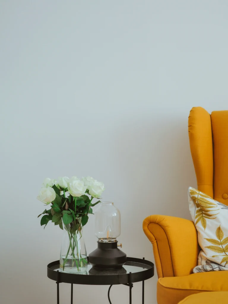 Cozy corner with mustard armchair and white roses