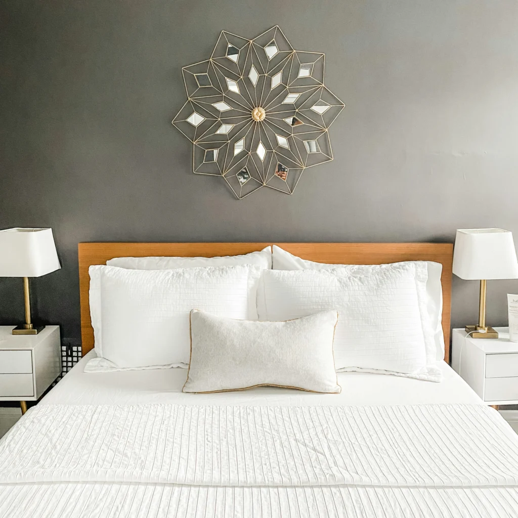 Serene bedroom with white bedding and gold lamps