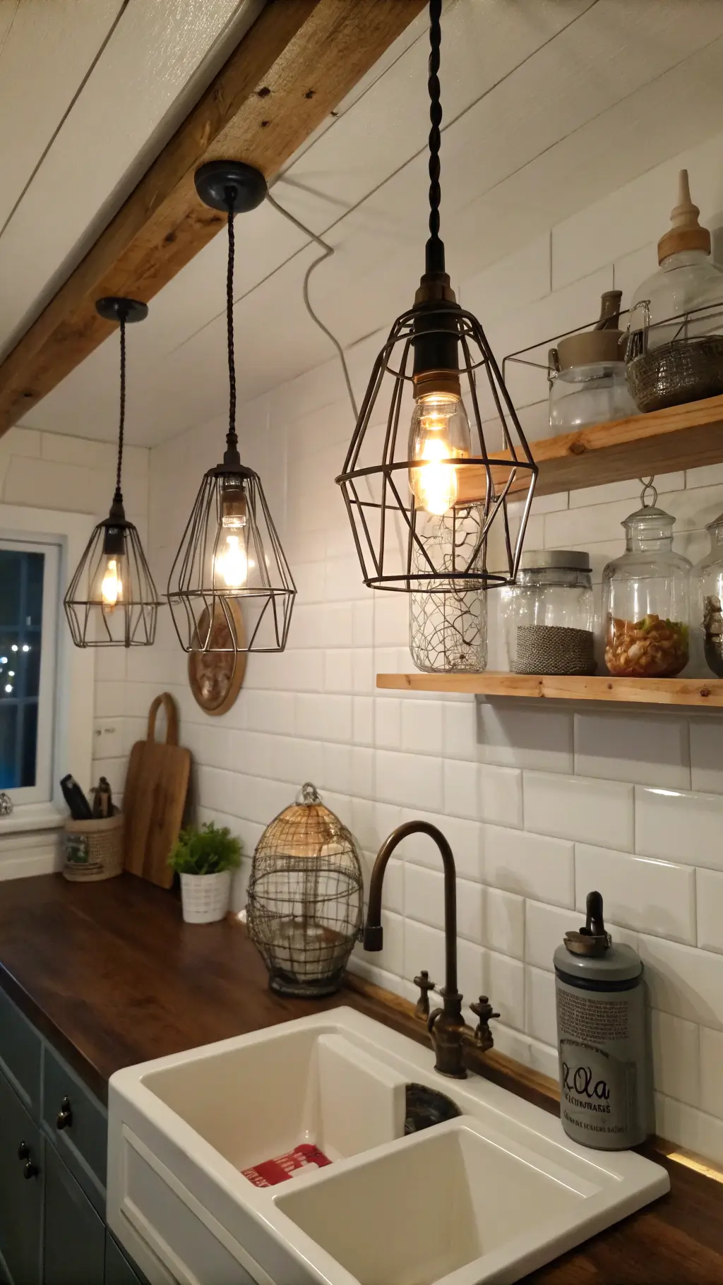 DIY cage light pendants above farmhouse sink in budget-friendly kitchen makeover