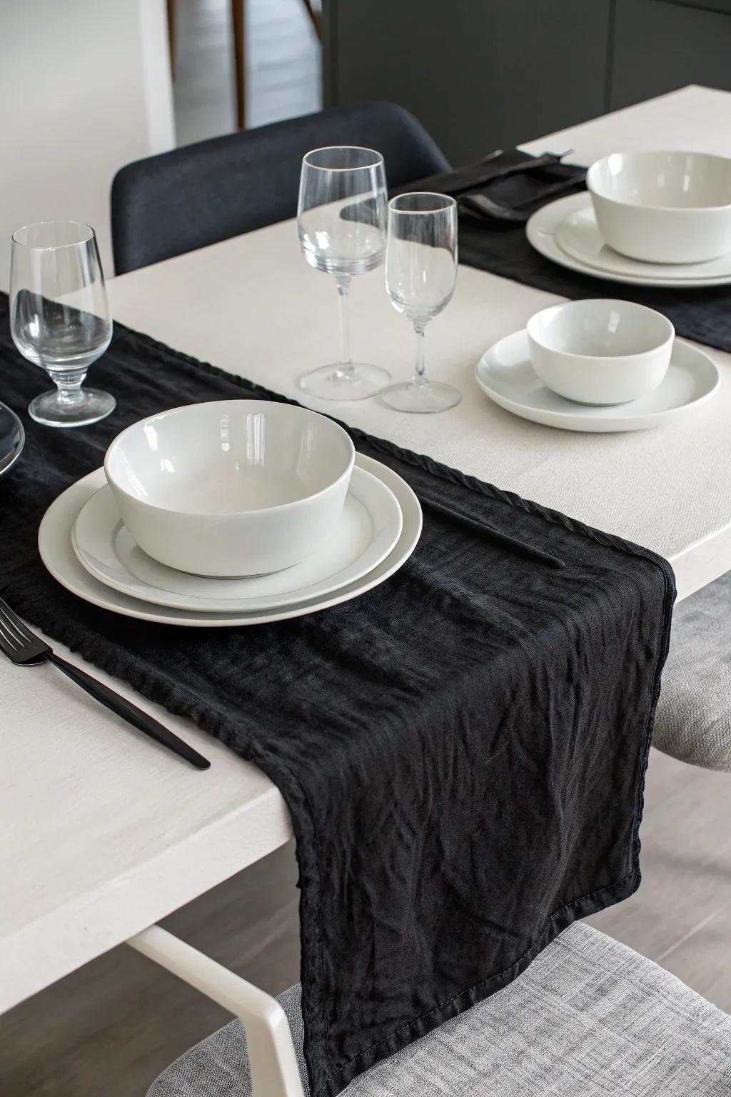 Black cheesecloth runner with white tableware