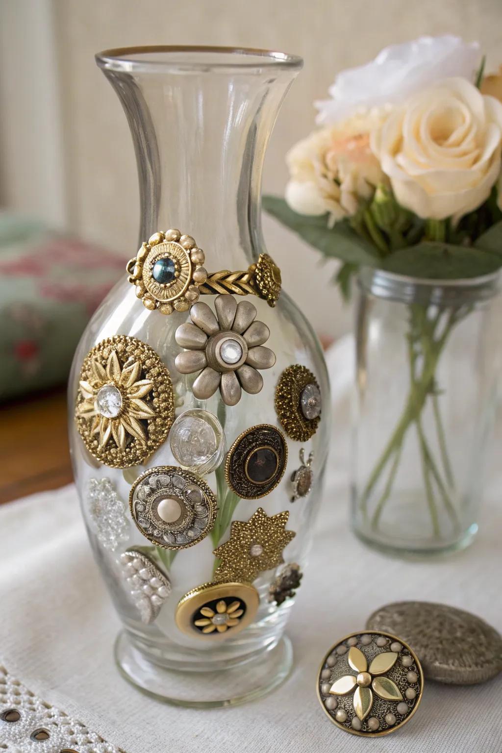 A glass vase adorned with vintage buttons and brooches for a nostalgic look.
