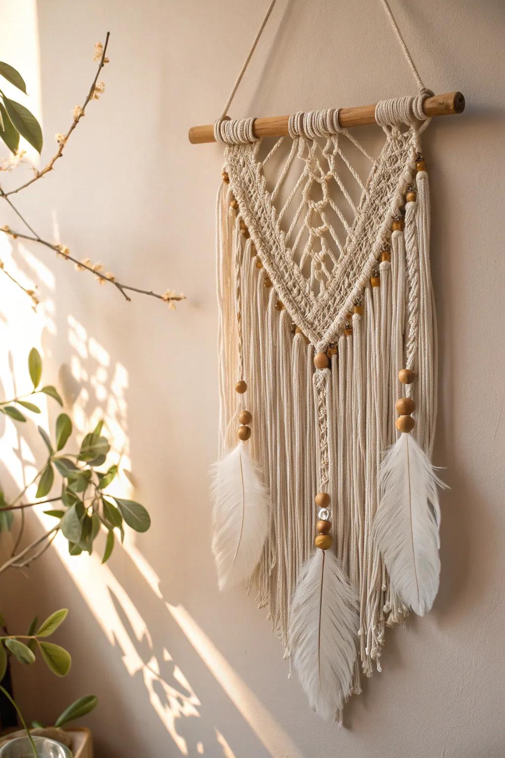 Boho-inspired yarn wall art enhanced with beads and feathers.