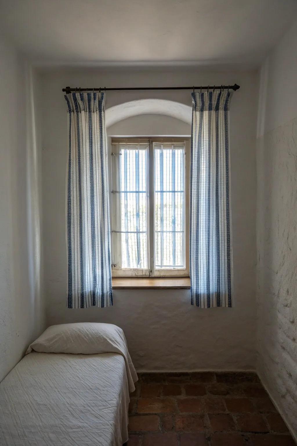 Vertical striped curtains creating an illusion of height.