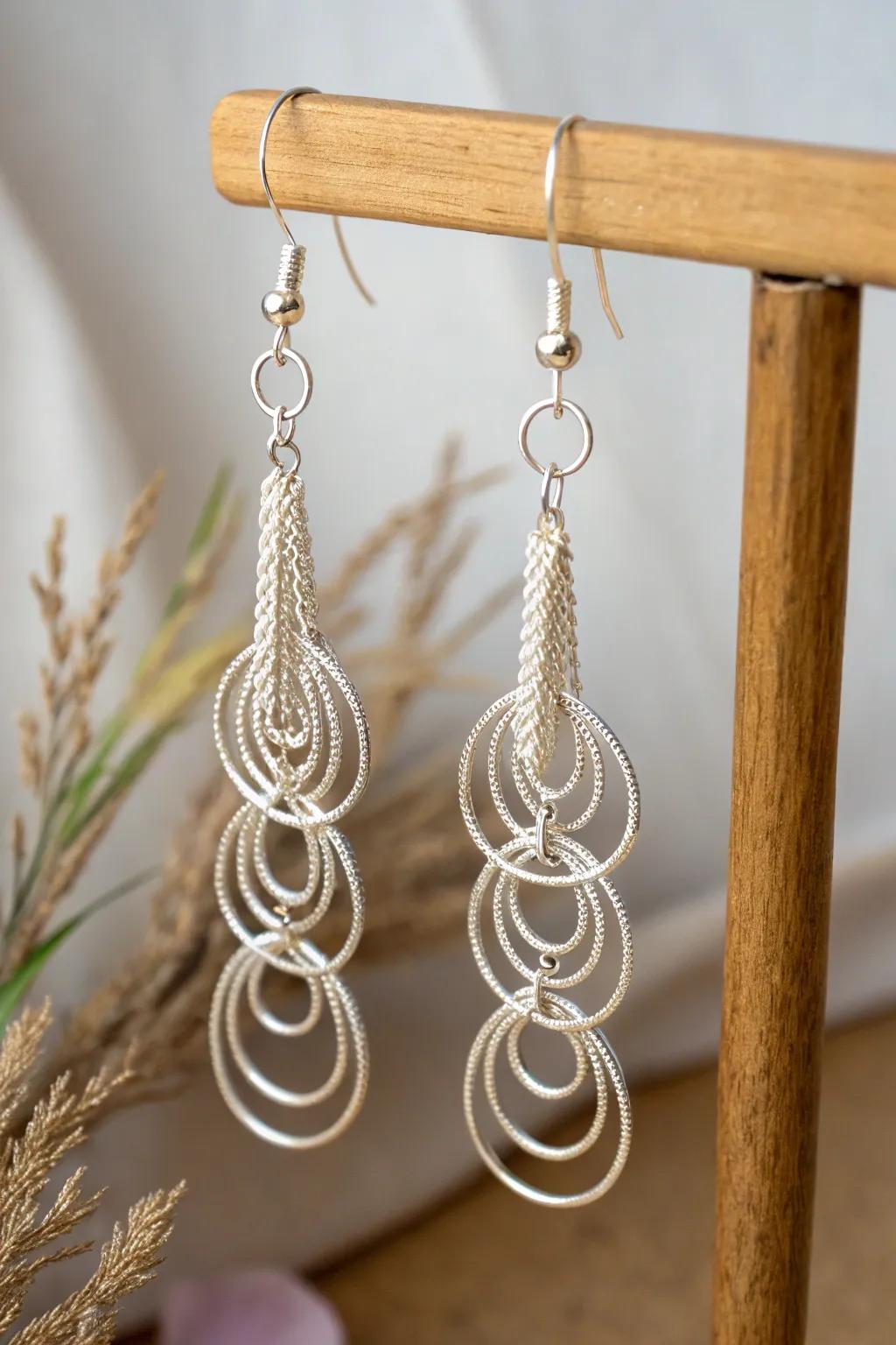 Elegant dangle earrings featuring cascading wire loops that create movement and charm.