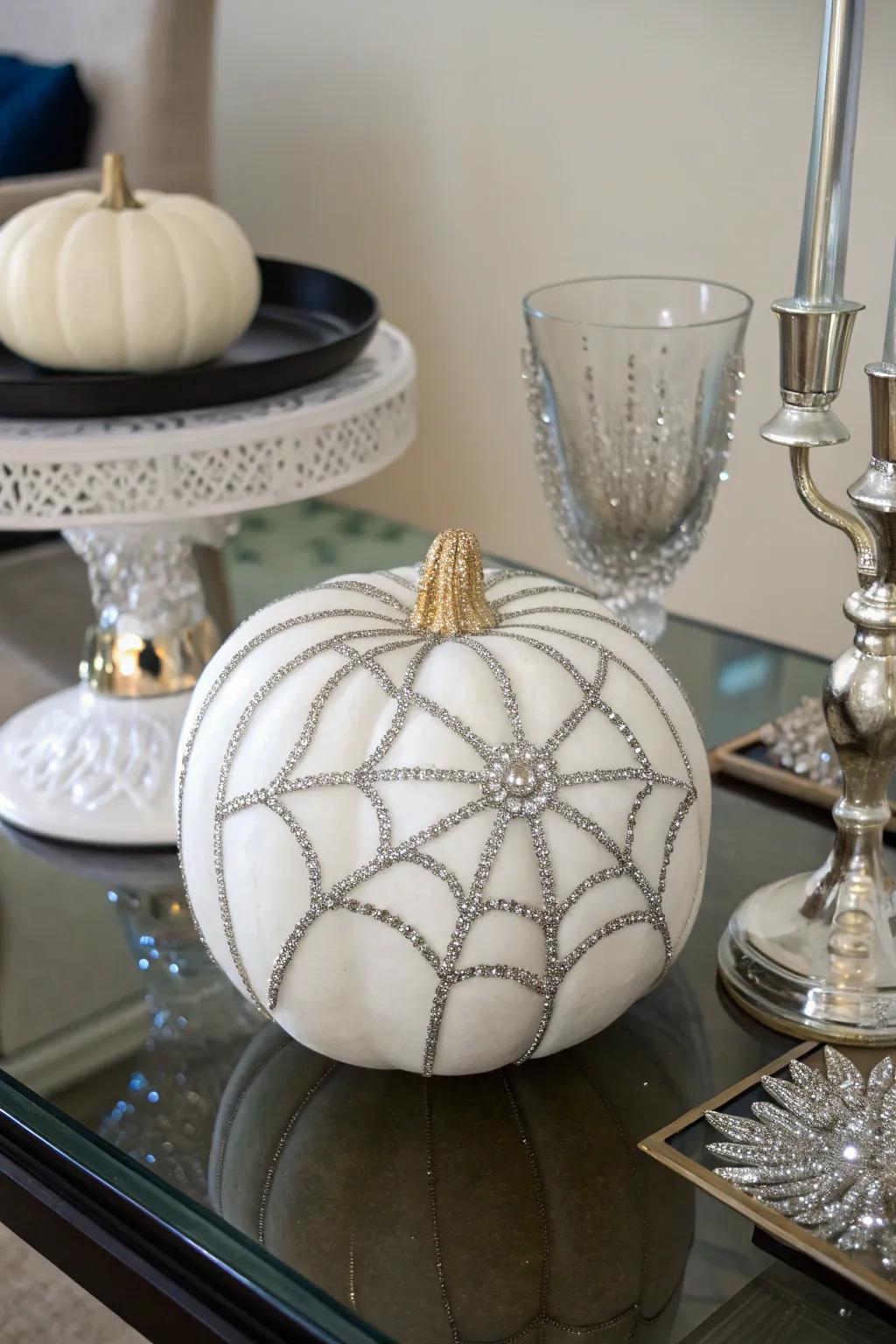 Artificial pumpkin adorned with shimmering rhinestone spider web