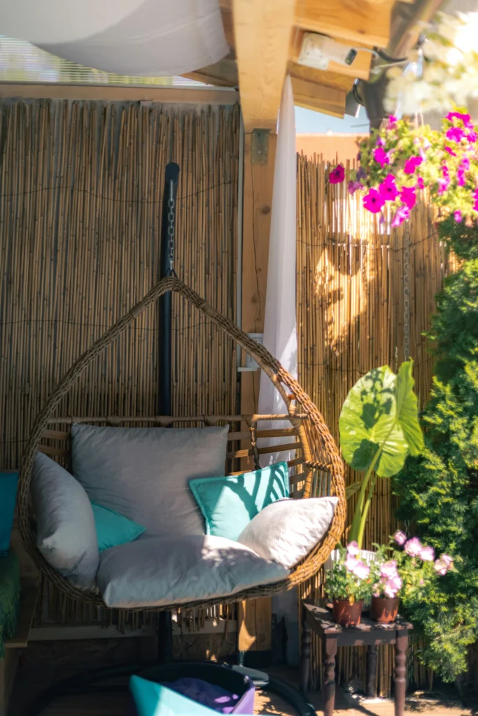 Boho style outdoor seating with wicker chair and bamboo screen