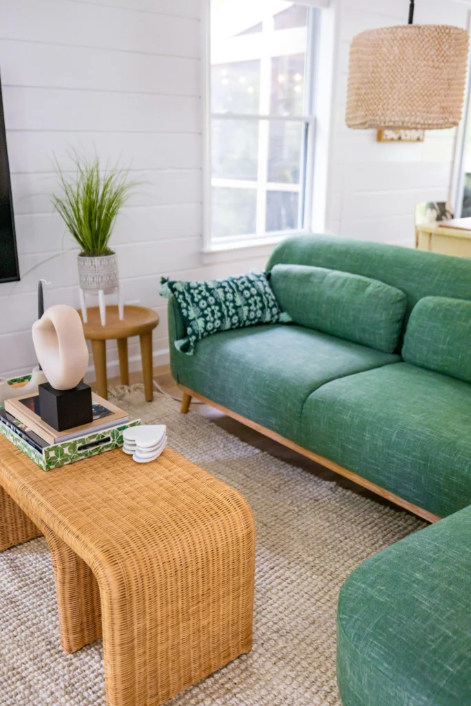 Living room with green sofa and natural textures